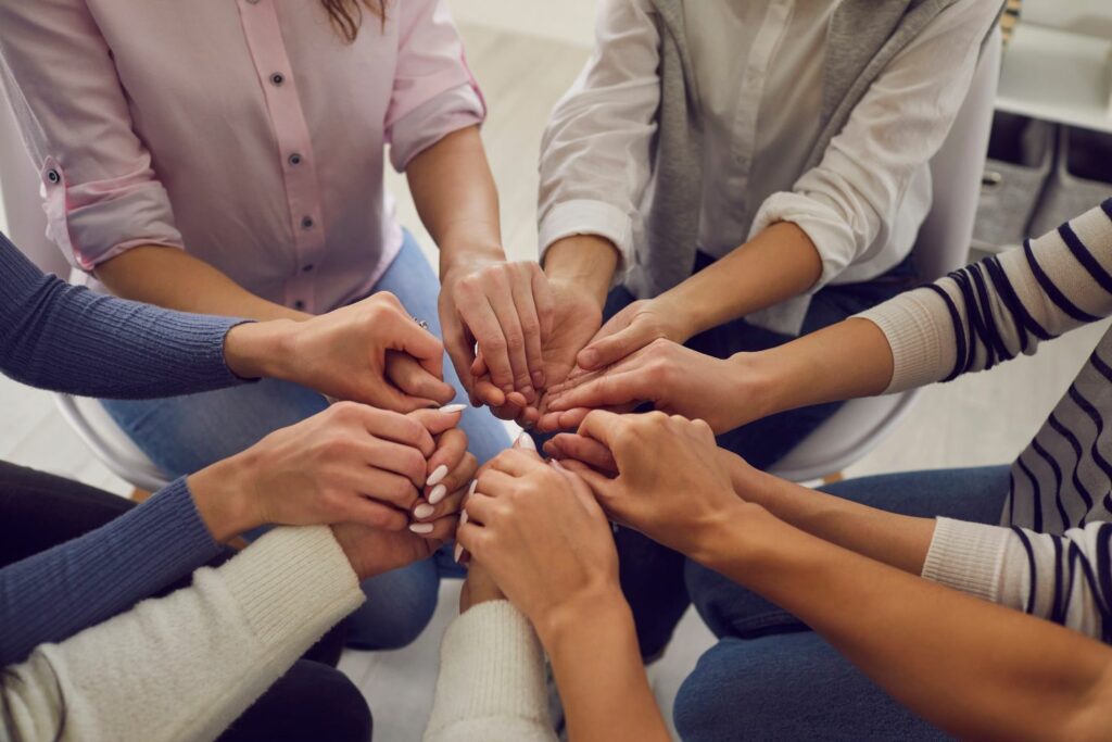 our team - group of women holding hands